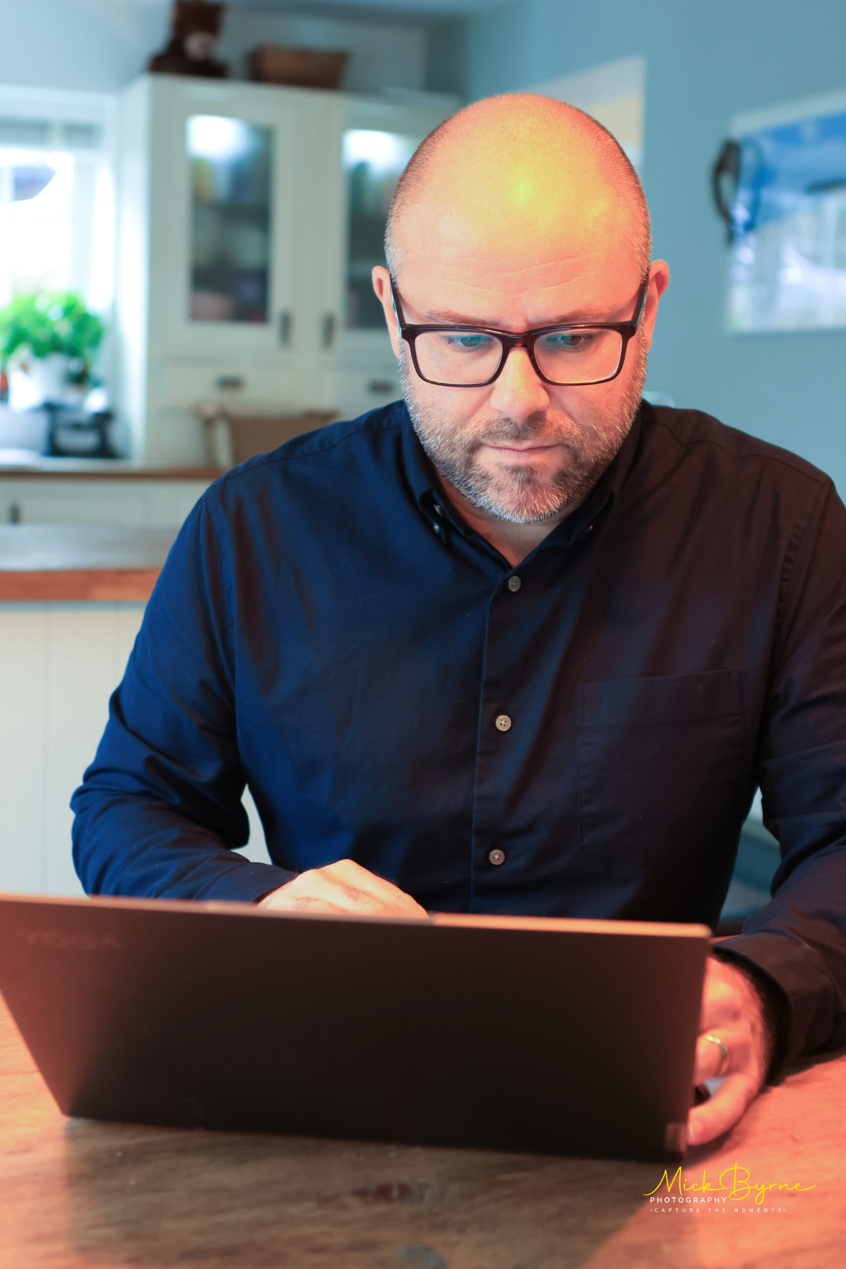 Mortgage advisor working on a laptop, providing insights and guidance for first-time buyers in the UK.